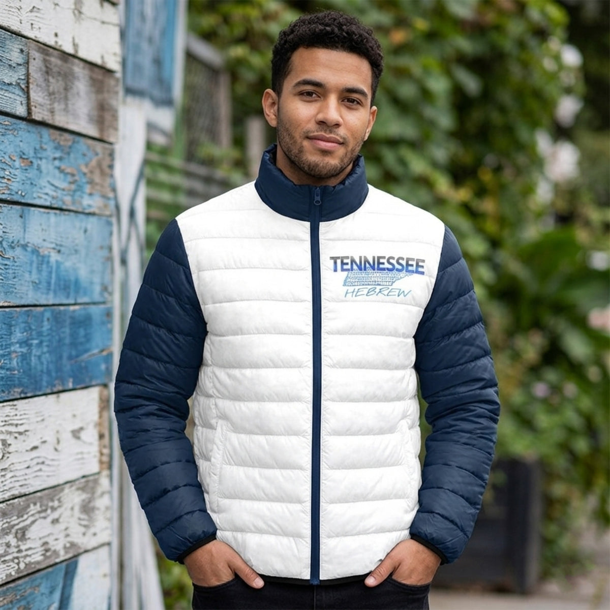 
Gemini said
A man wearing a white and navy puffer jacket with "TENNESSEE HEBREW" and a state map outline on the chest.